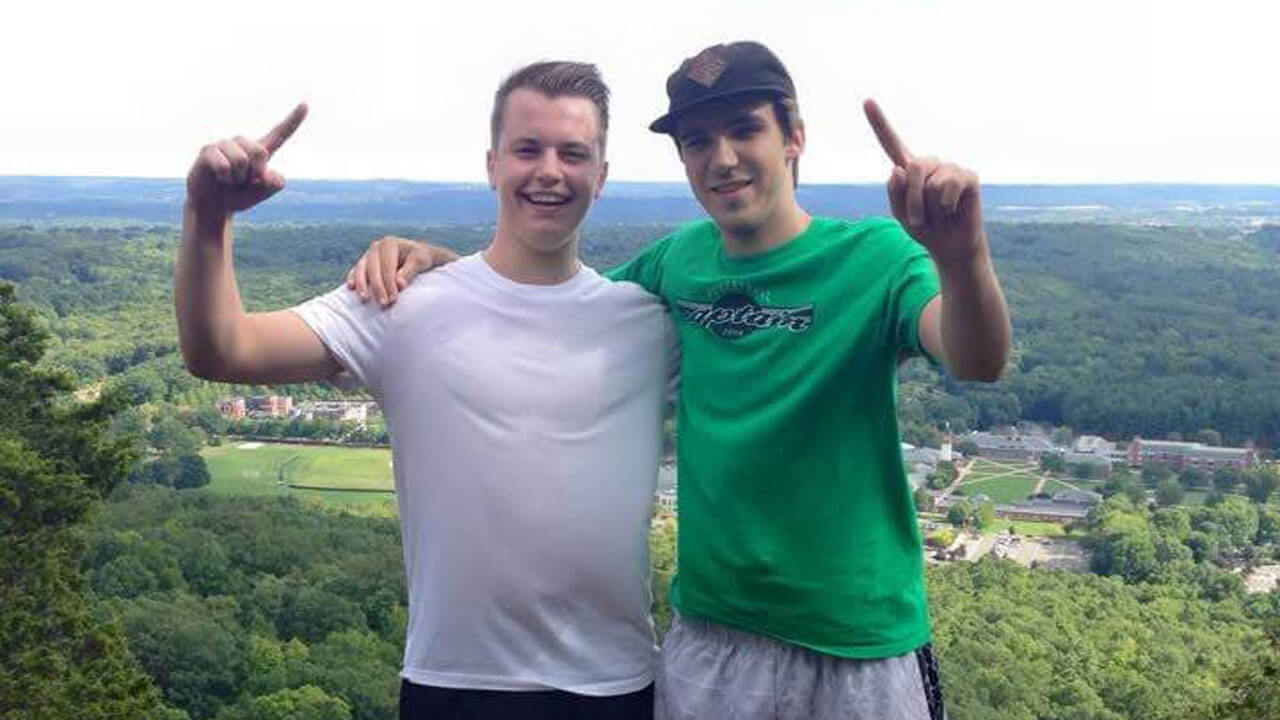 Kyle Adams and Matt Warner pose for a picture at the top of Sleeping Giant Mountain