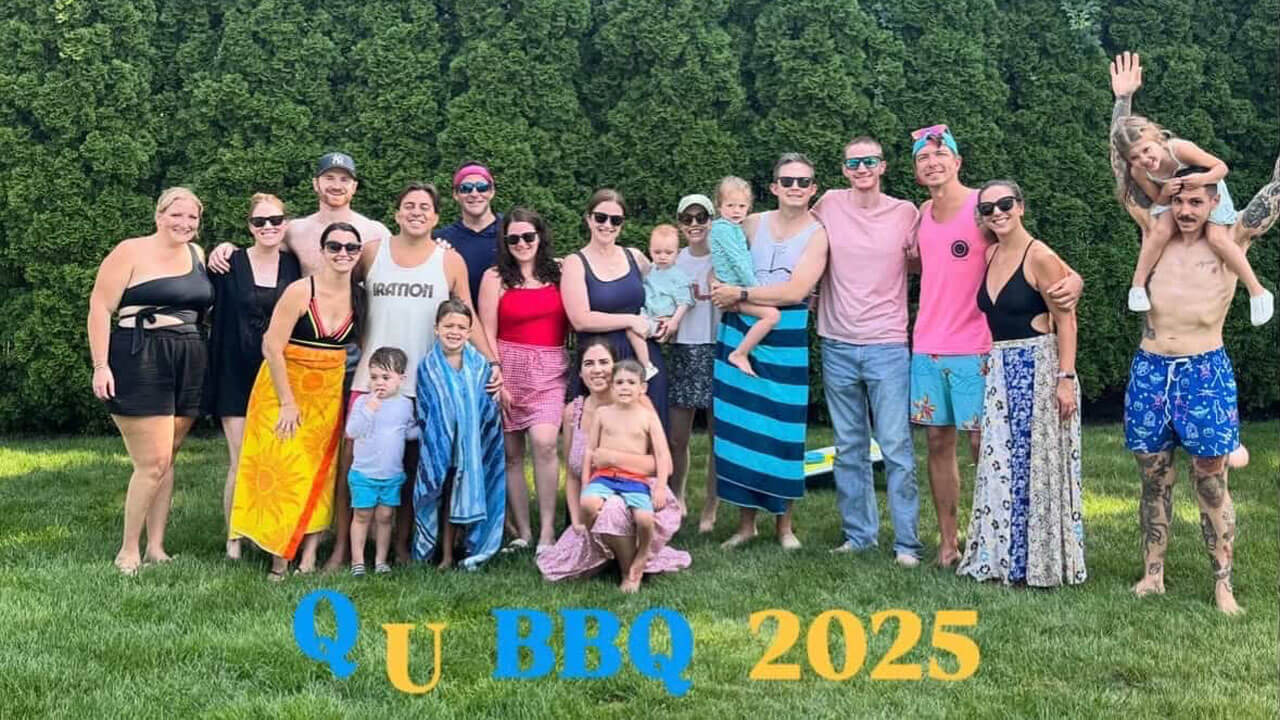 Quinnipiac alumna, Gina McAllister, poses for a picture with several Quinnipiac alumni outside