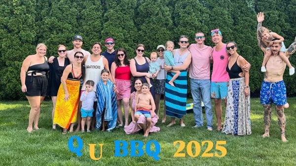 Quinnipiac alumna, Gina McAllister, poses for a picture with several Quinnipiac alumni outside