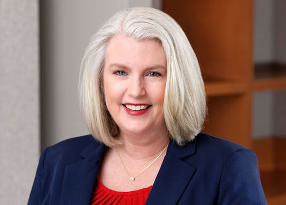 Robyn Swanson smiling in a blue and red top