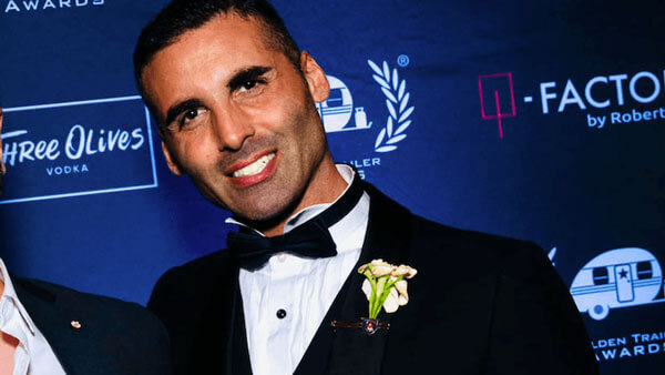 Brendan Amoruso in a tuxedo posing for a photo