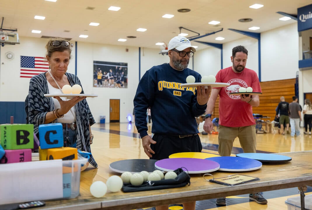 Families can be seen playing a balancing game