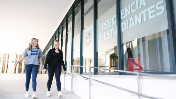 2 female students walking outside