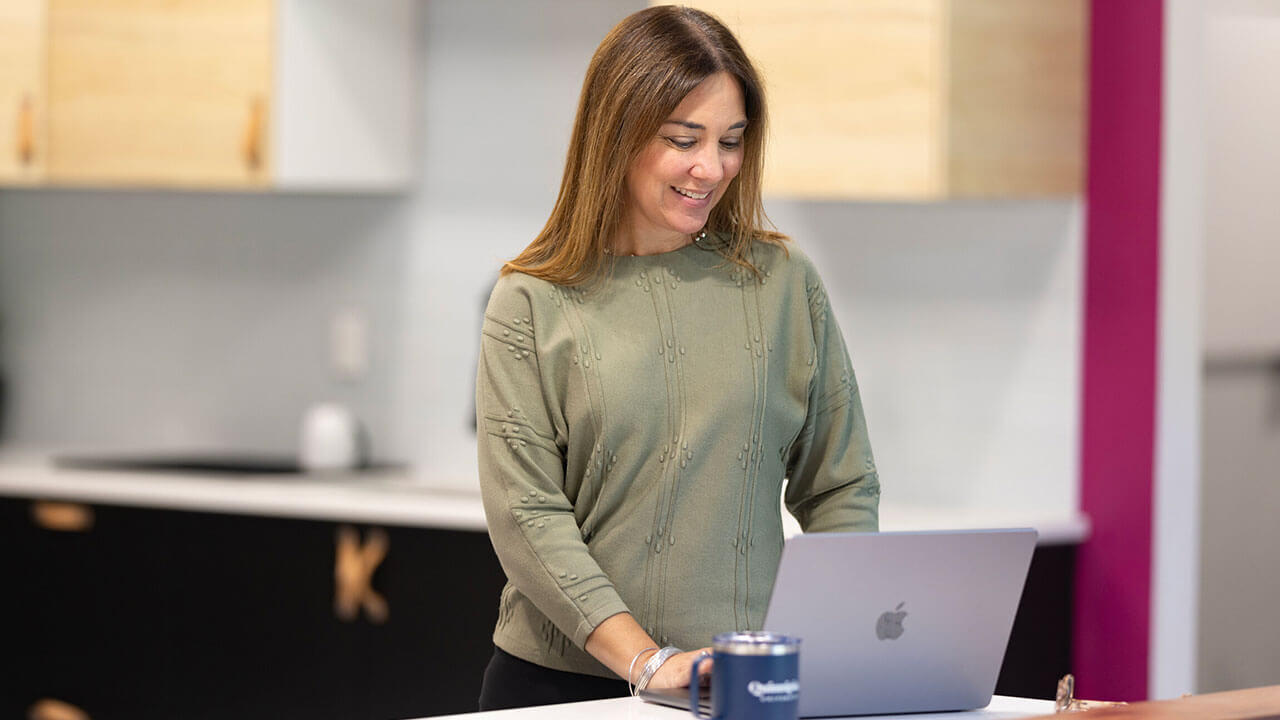 Graduate student adult learner working on a laptop