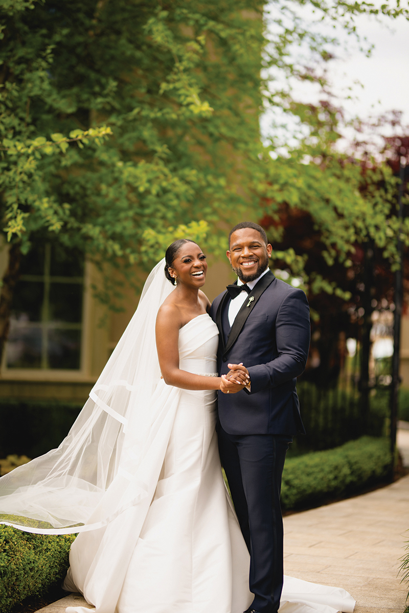 Asia (Skyers) Sumner and Bryan Sumner smile and hold hands on their wedding day