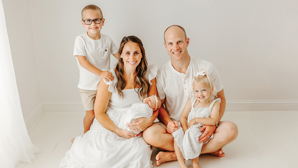 Keith Yatauro and Erica Yatauro pose for a photo with their two young children and new infant