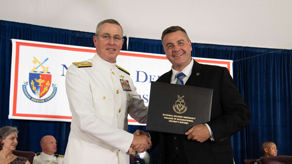 Jeremiah	Cottle in his military uniform receiving his diploma from National Defense University