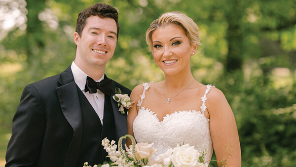 Alex (Larsen) Hull and her husband pose for a photo together on their wedding day